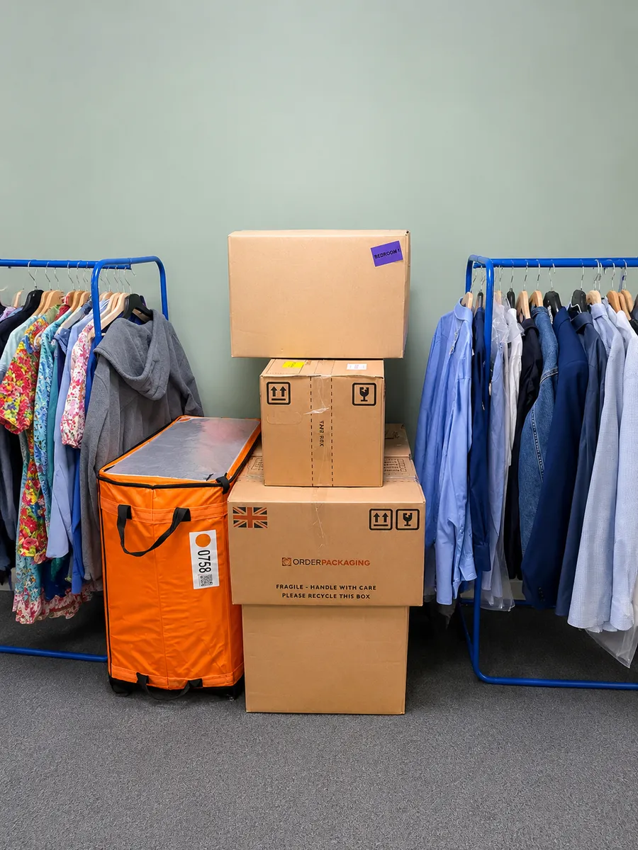 Clothes hung on rails and boxes packed by the Leaways Removals crew during a house move